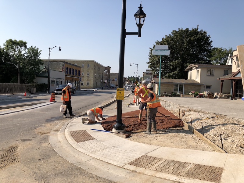 Workers pour coloured concrete as part of the Berford Street reconstruction in downtown Wiarton.