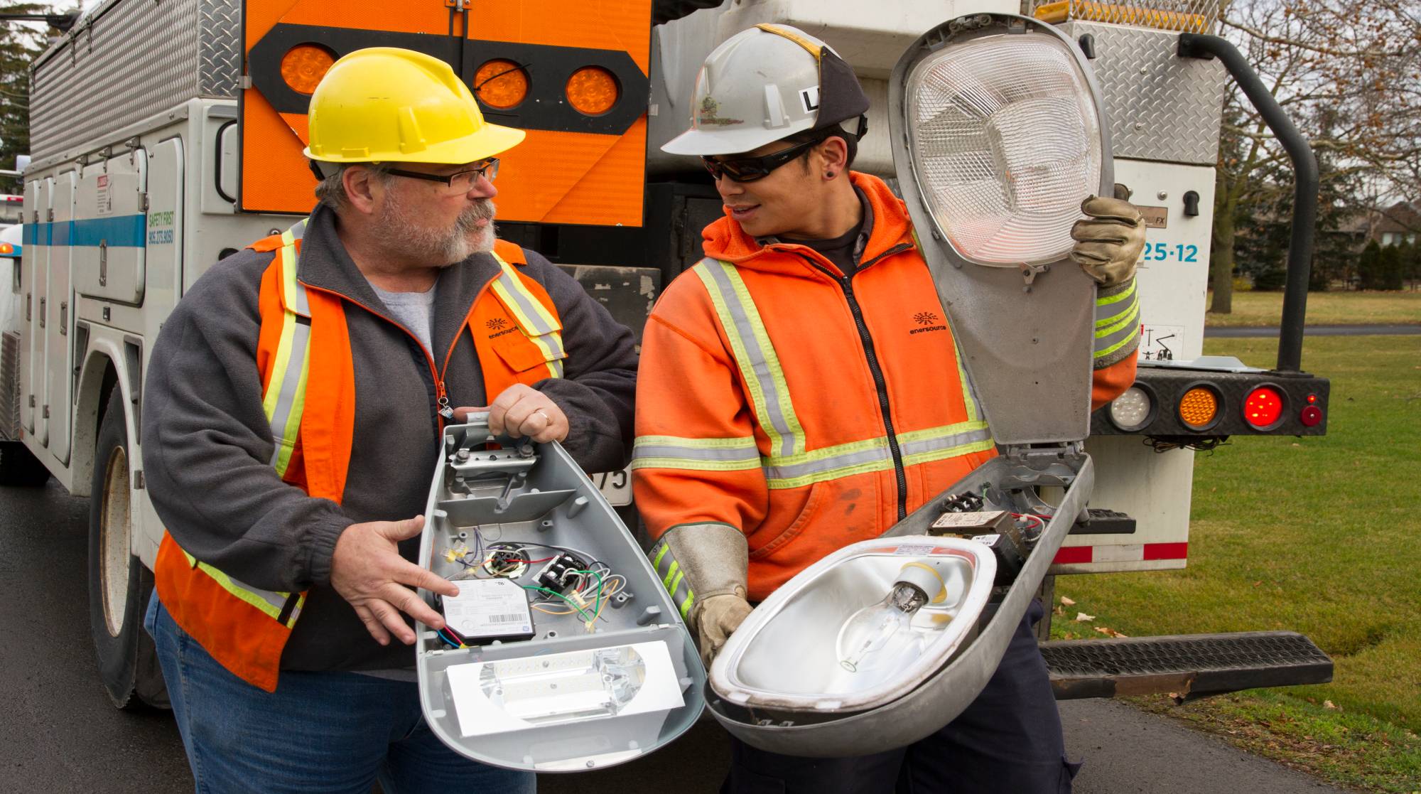 Two men analyzing a street light