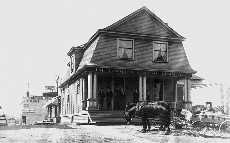 Old photo of a horse in front of a bank