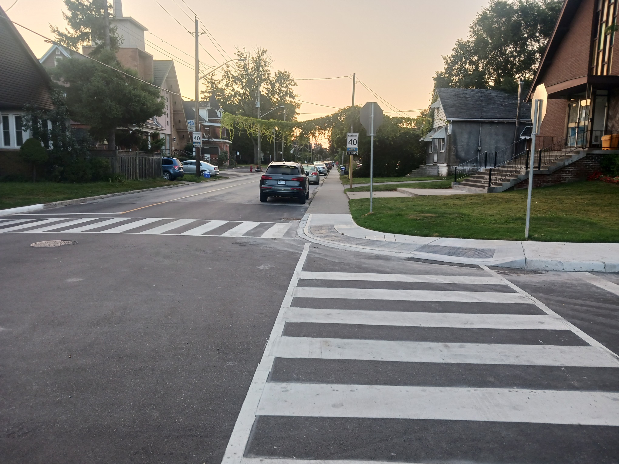 A paved residential road with a crosswalk