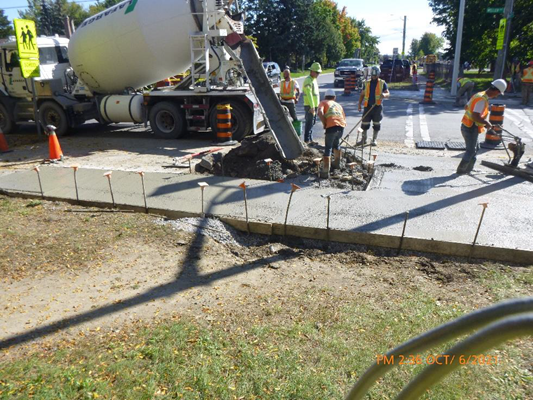 Construction workers building a sidewalk