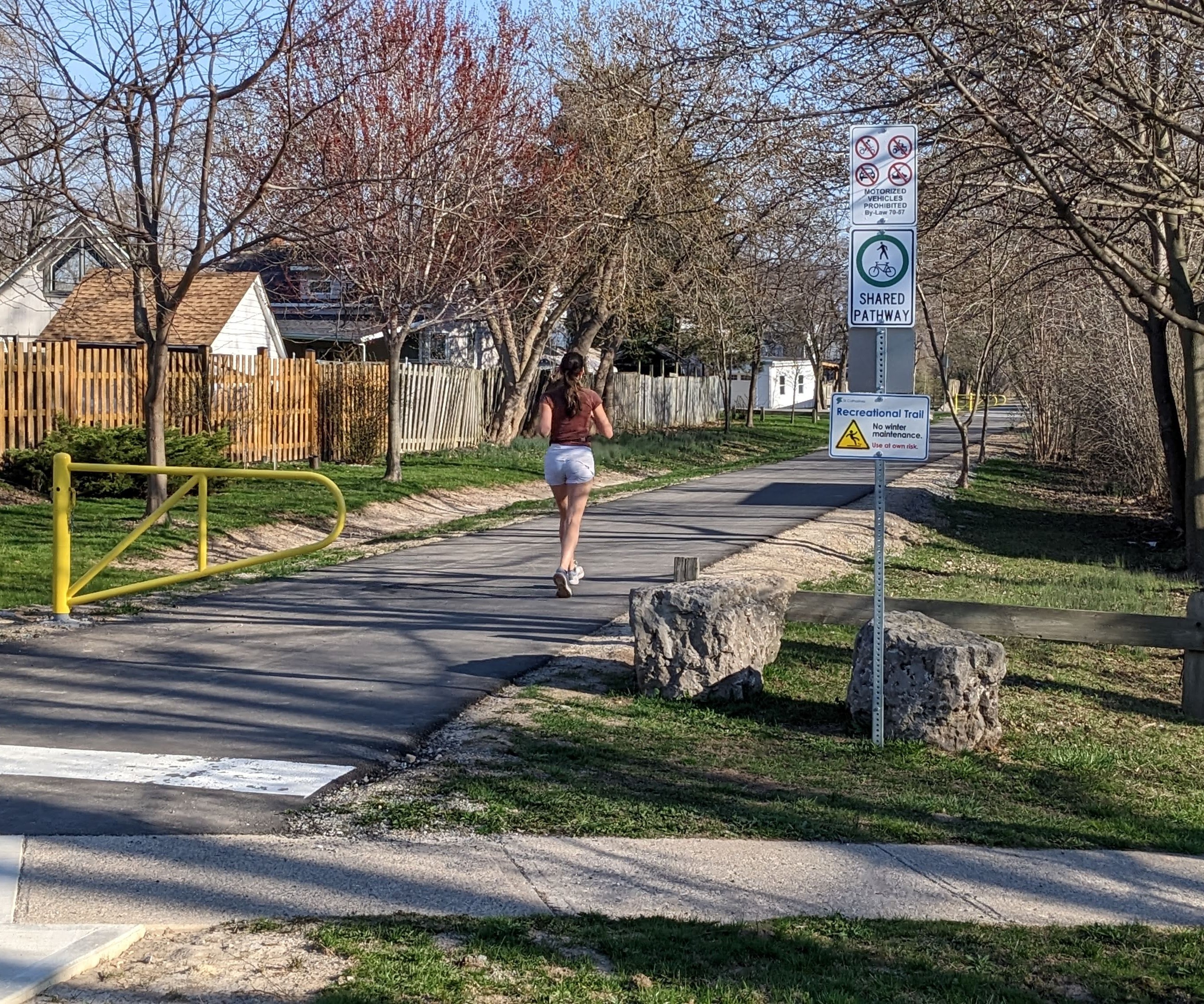 A woman running on a paved trail