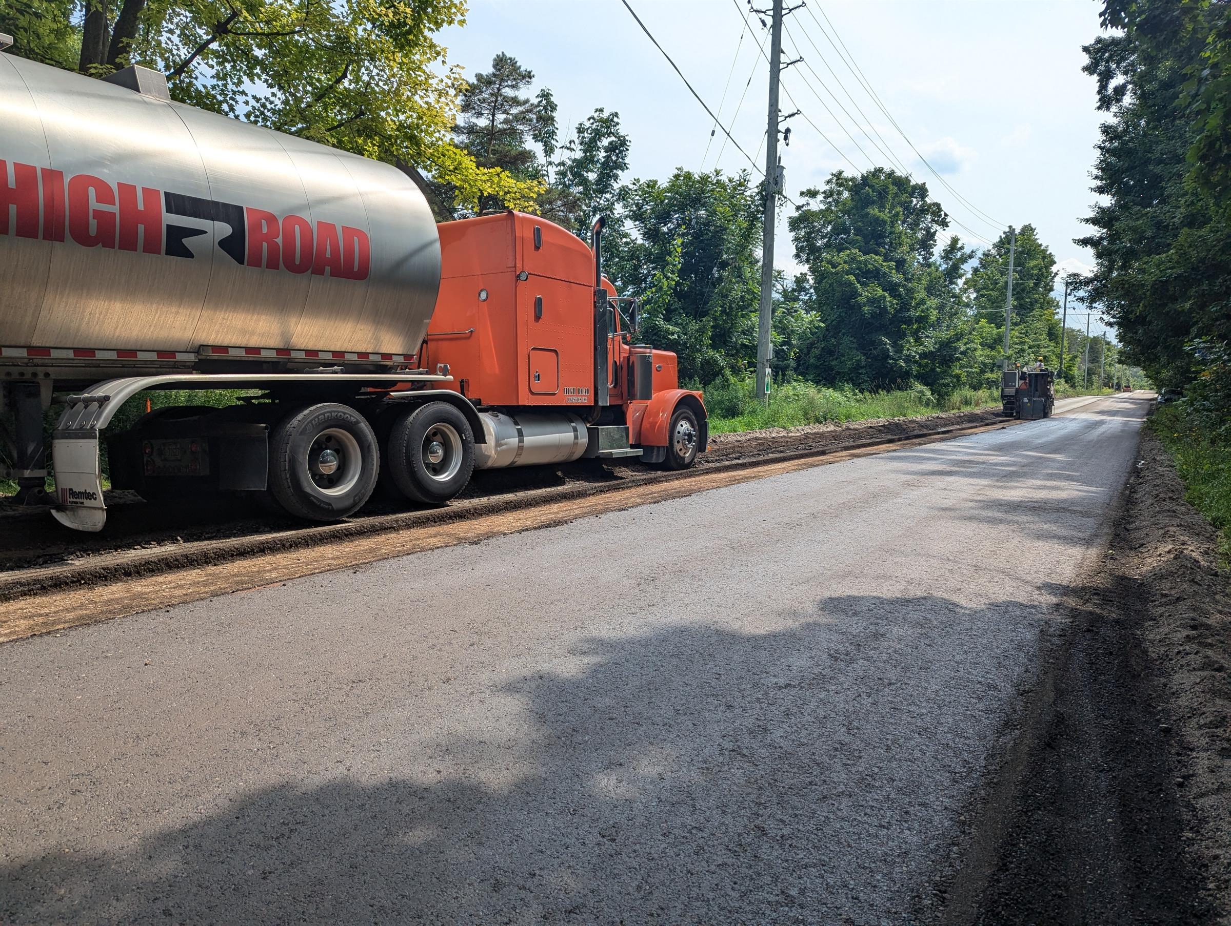 A big truck on a freshly paved road