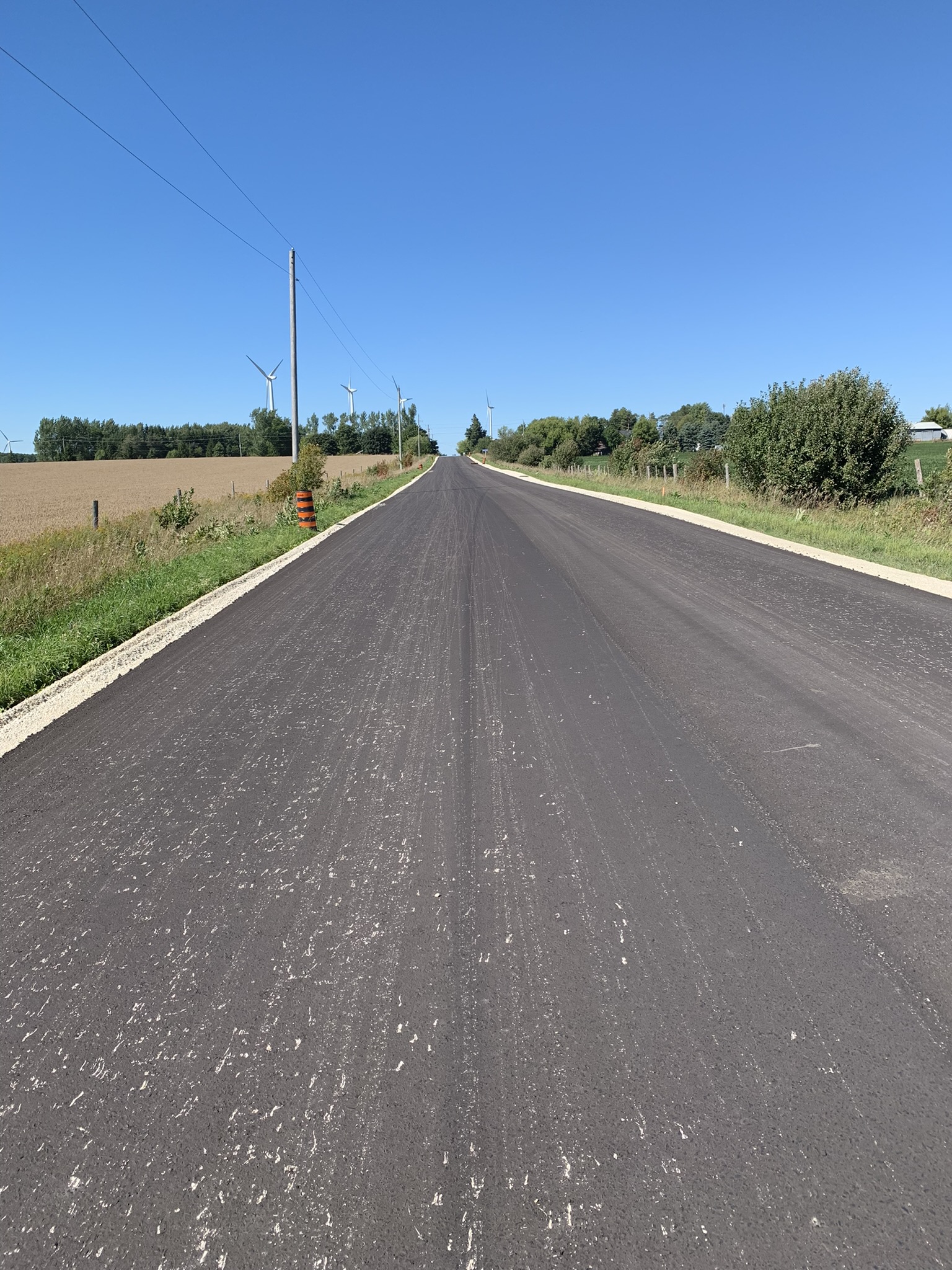Grey Road 63 in Grey Highlands shown with fresh asphalt.