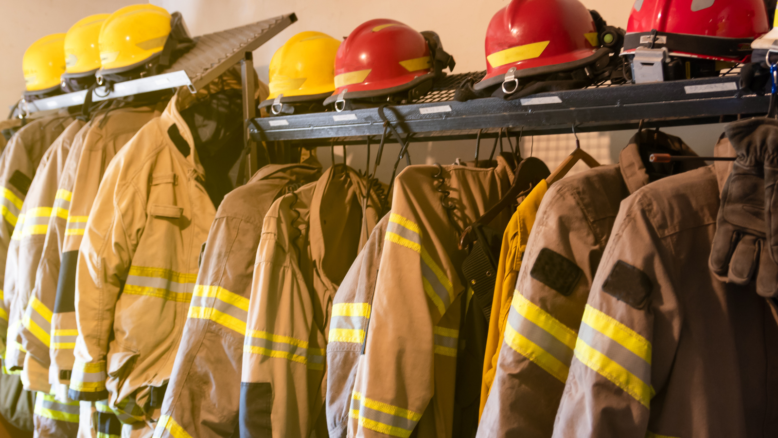A stock image of fire equipment hanging in a fire station. 
