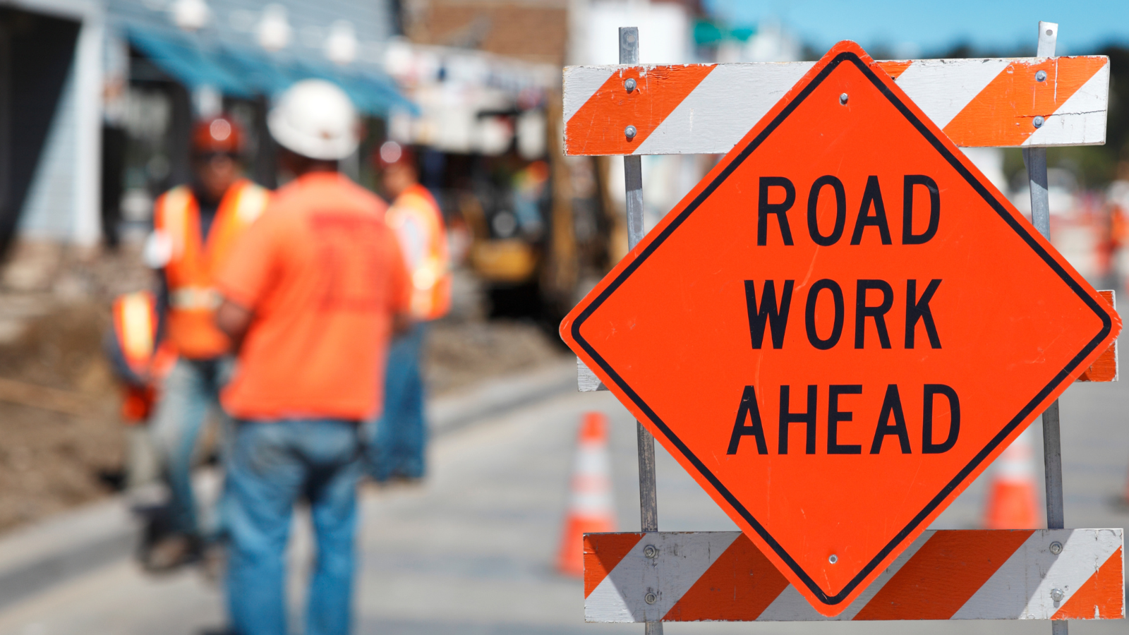 An orange sign that says 'roadwork ahead'. 