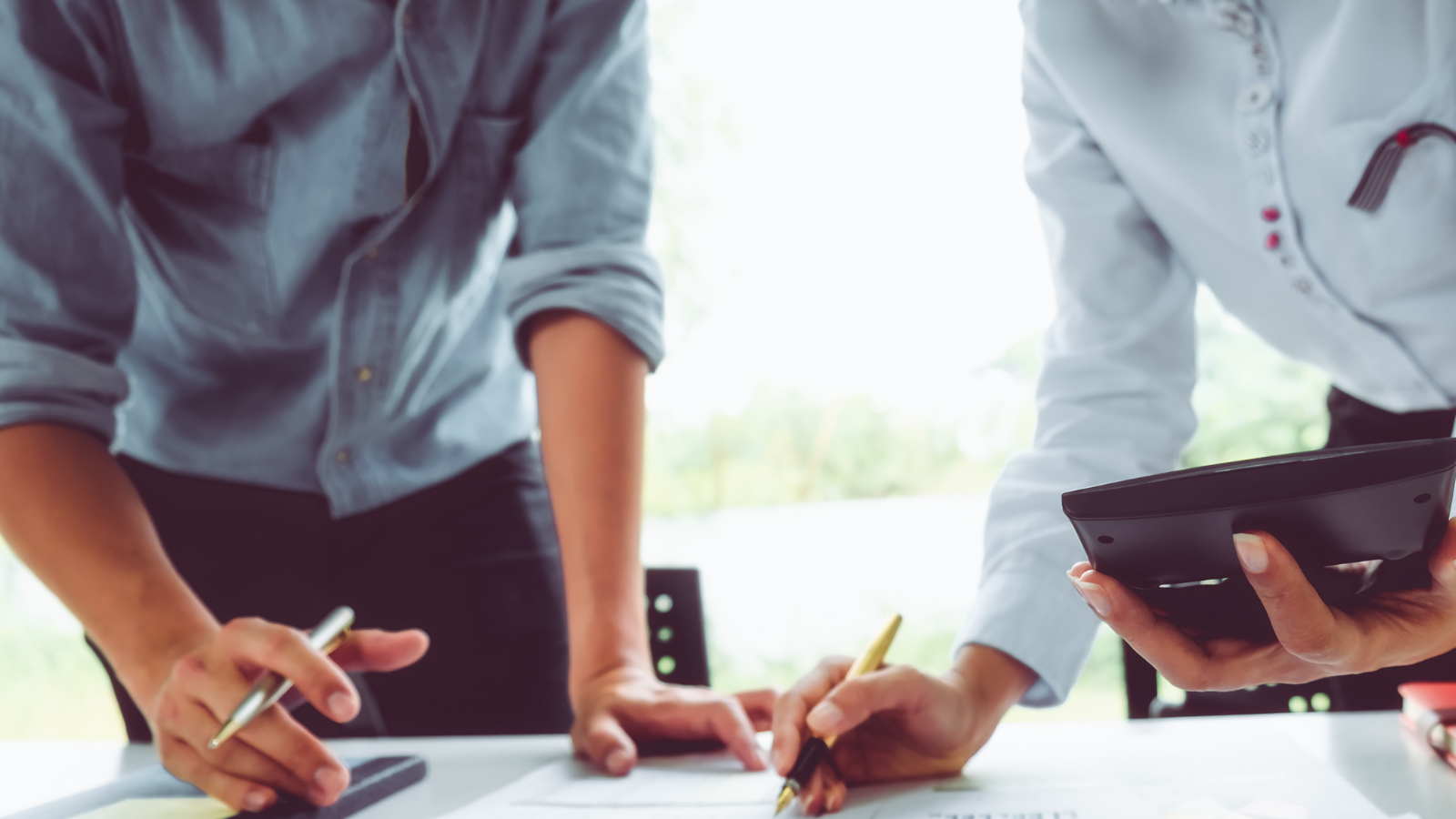 Stock image of two business people discussing asset management. 