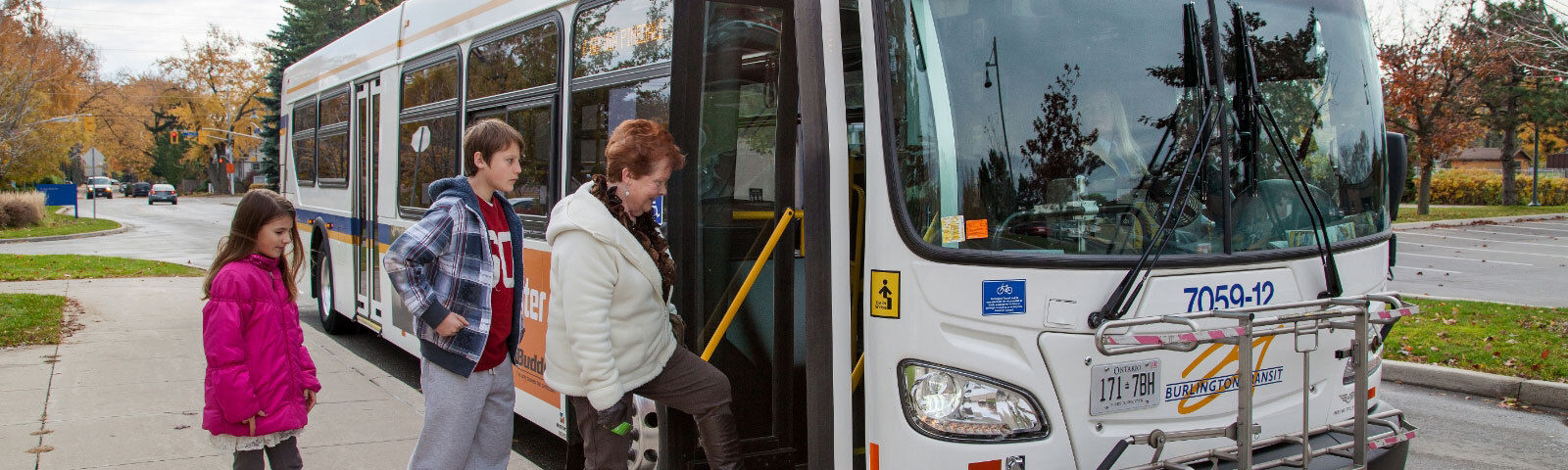 Transit users getting on to a city bus in Burlington.