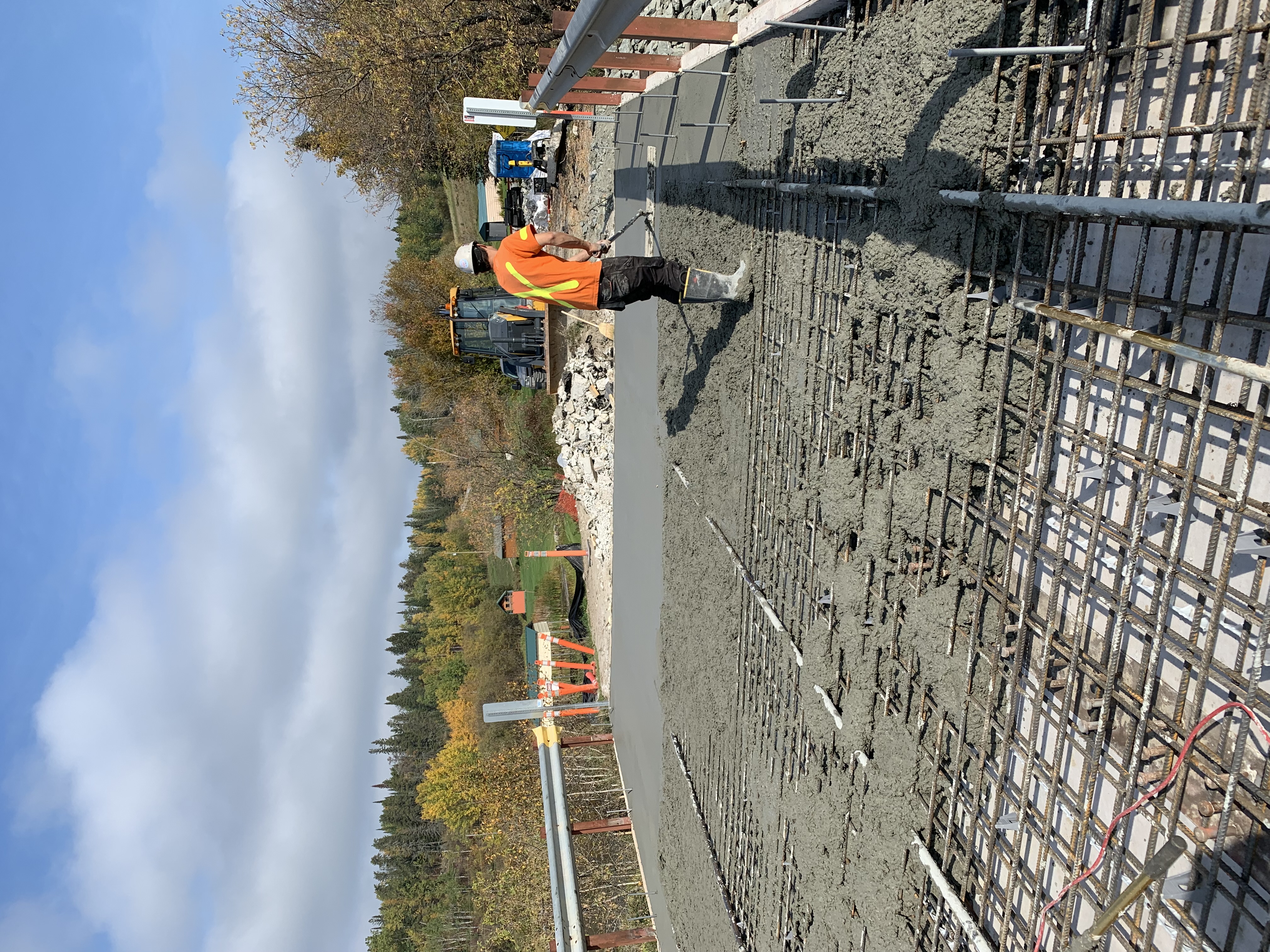 Workers smooth asphalt on a bridge in Kenora.