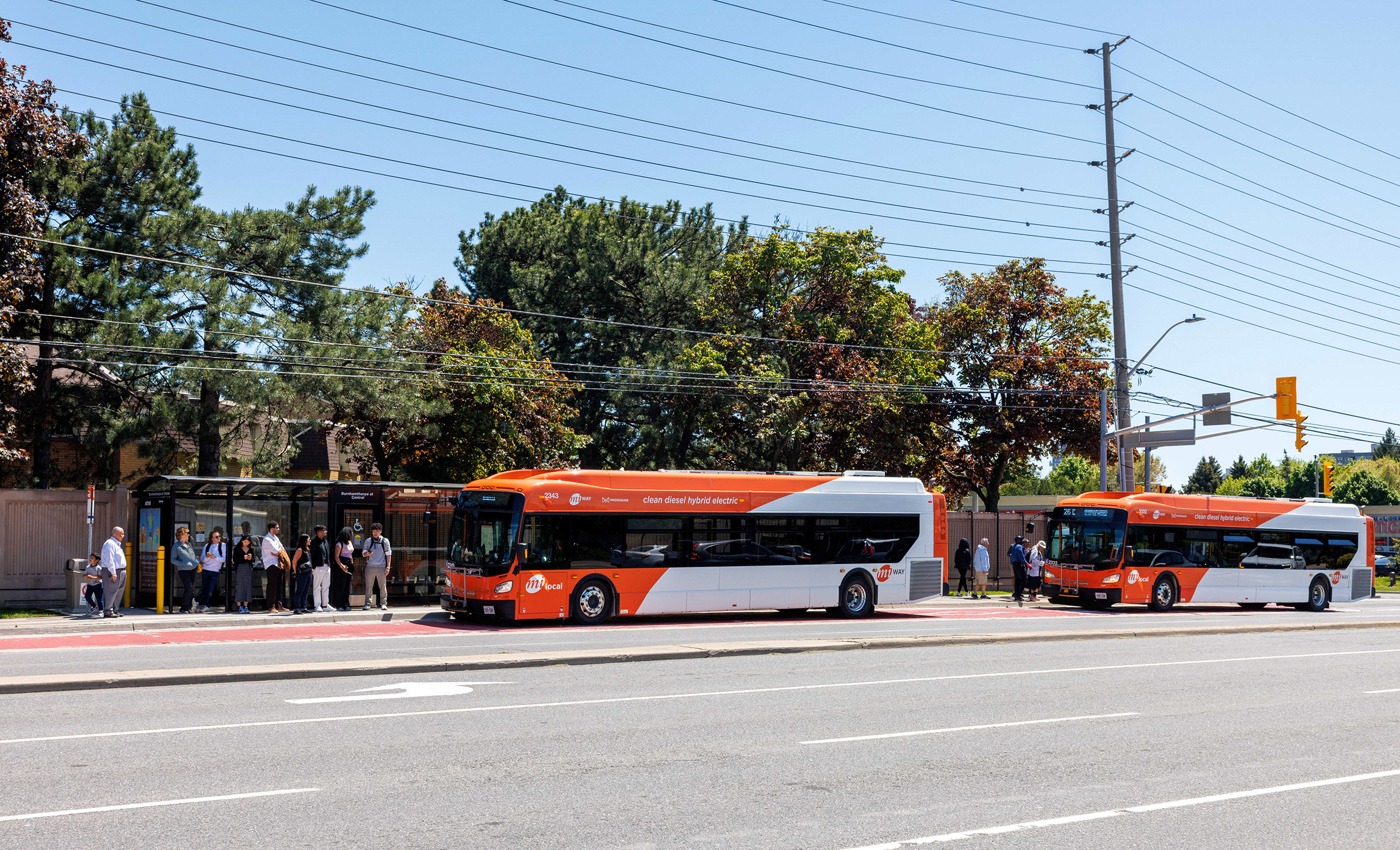 people loading buses at a bus station