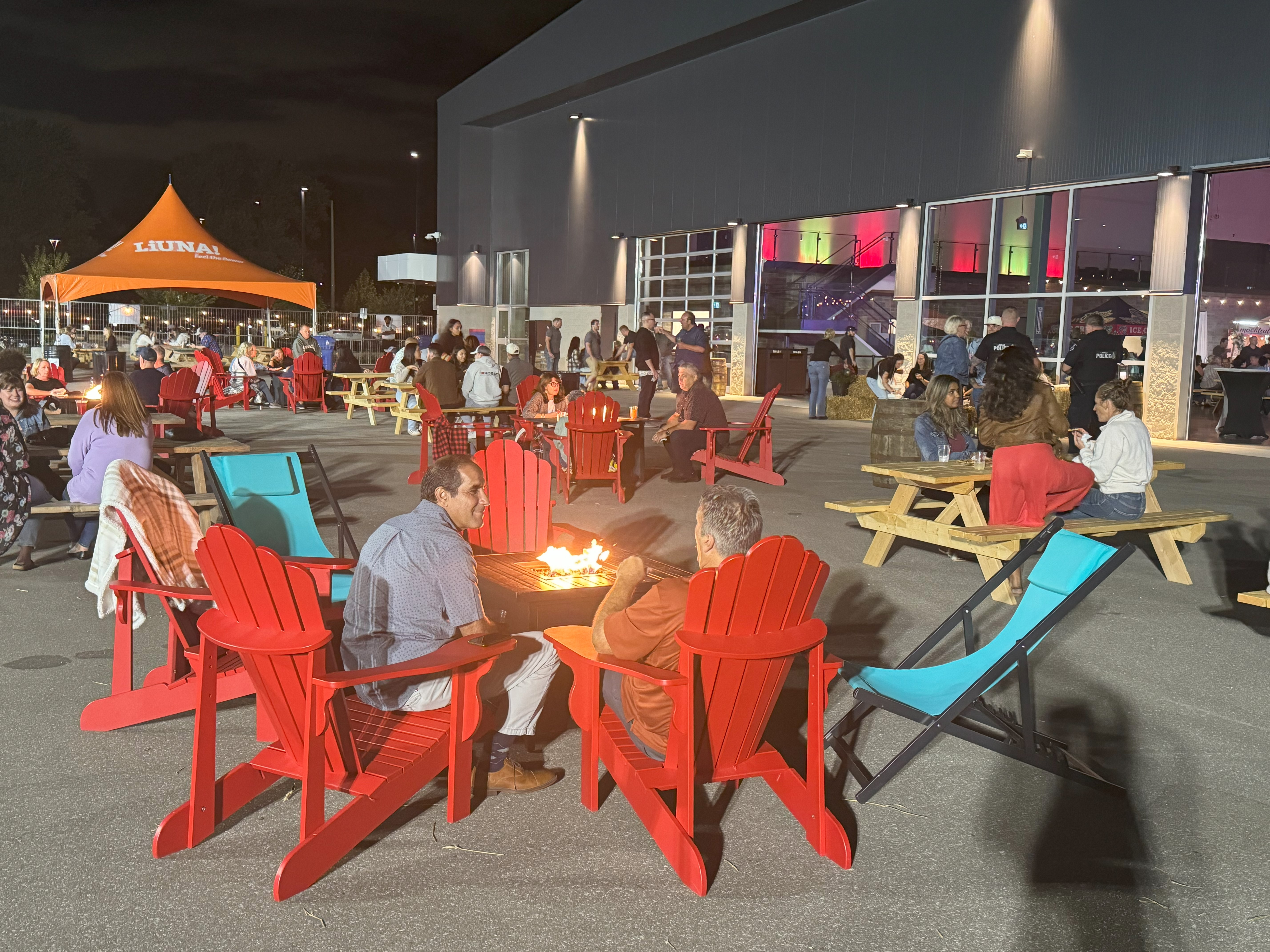 People sitting near several concrete campfires