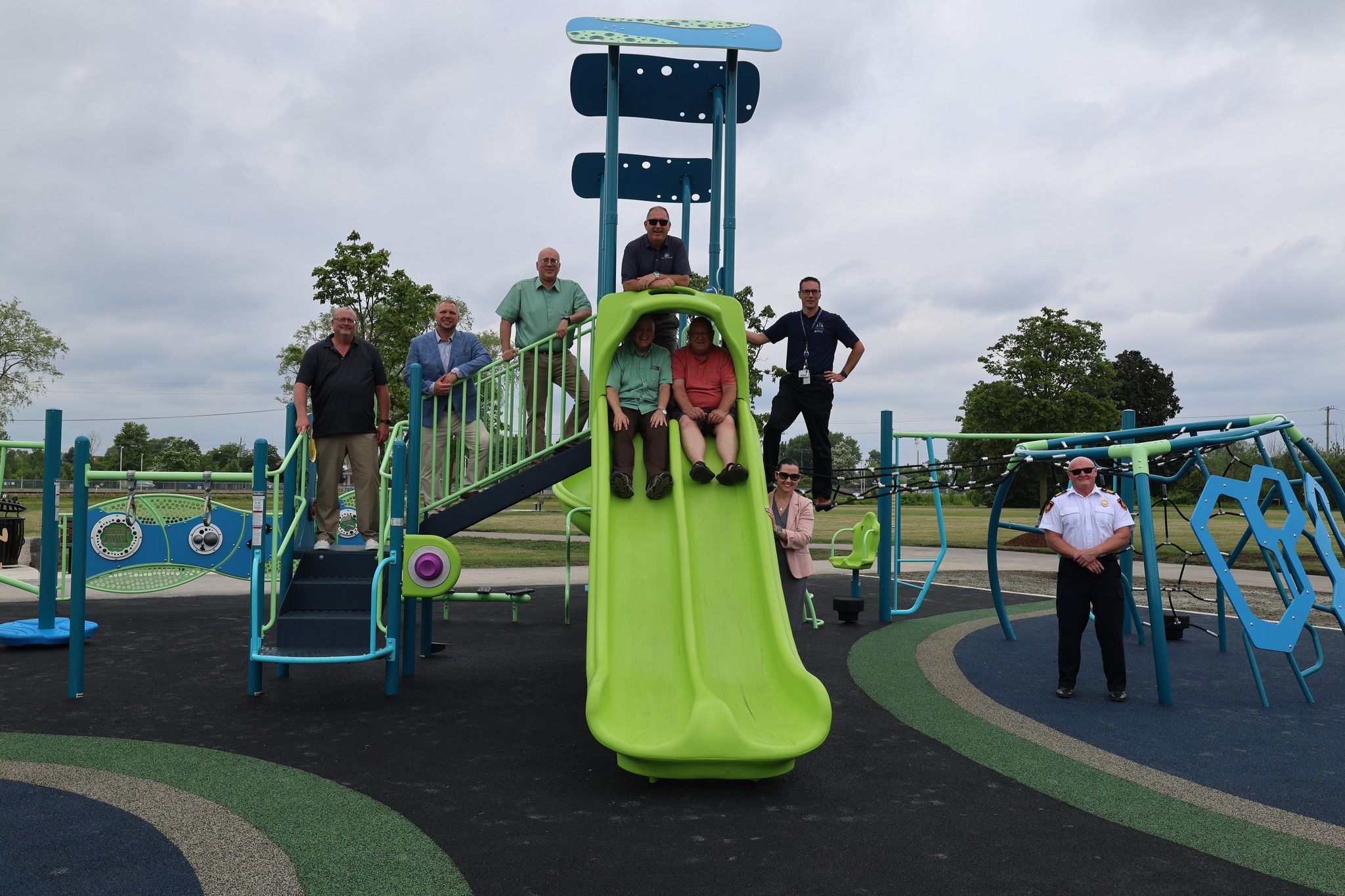 City staff posing on a play structure