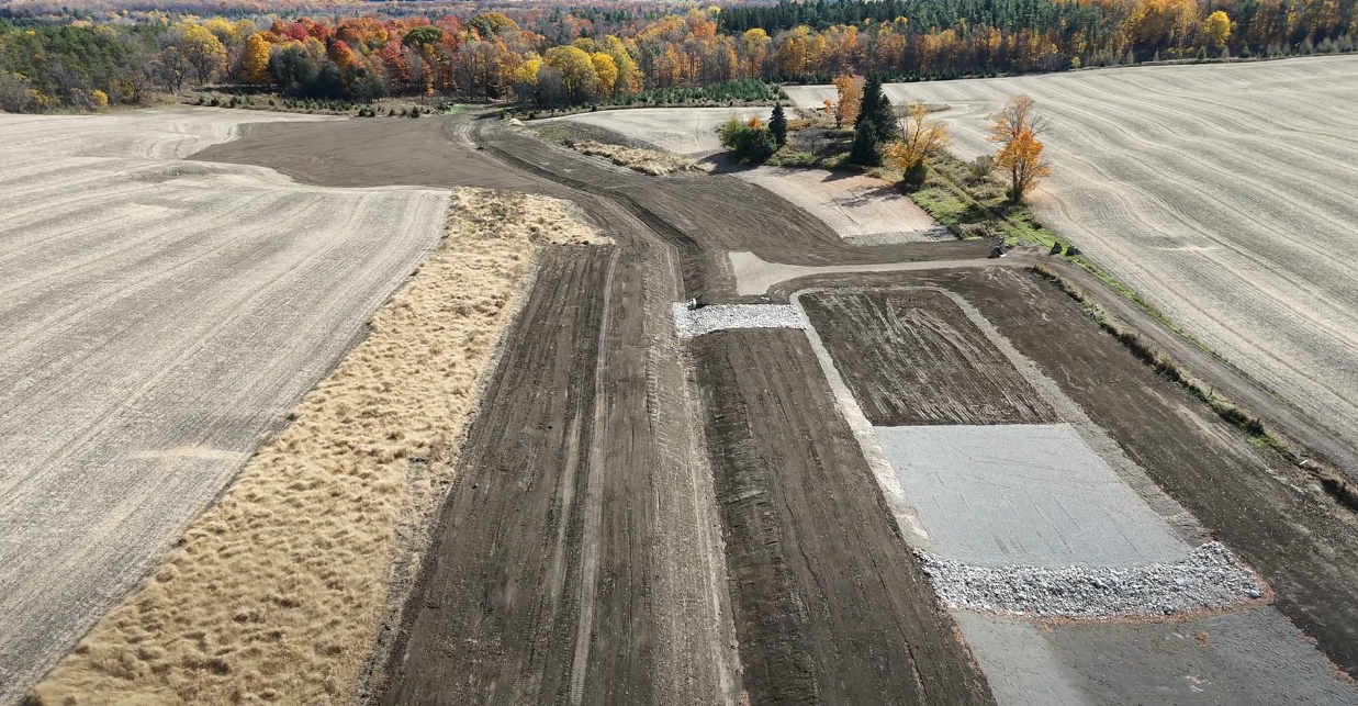 An overhead view of a field with space for a future drainage pond
