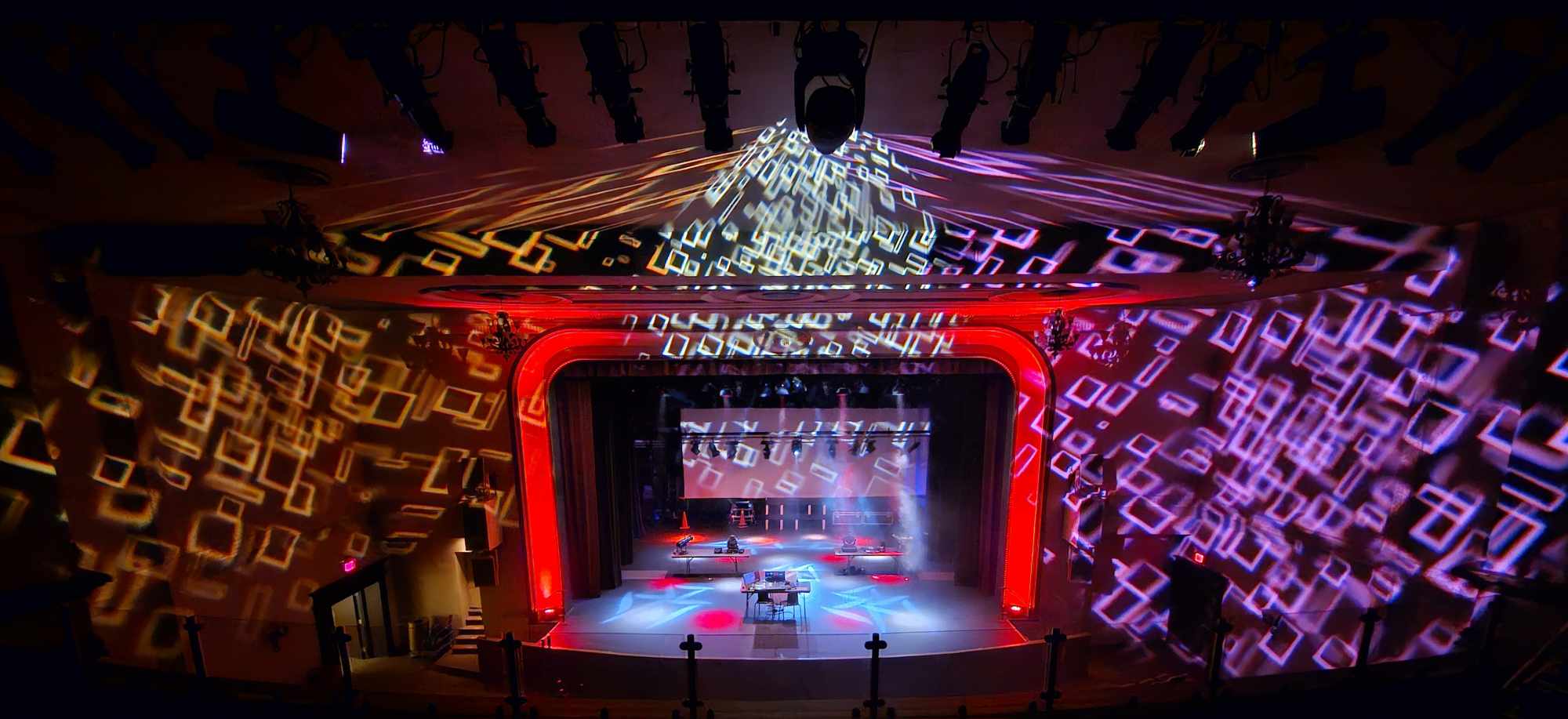 An auditorium stage with colourful lights