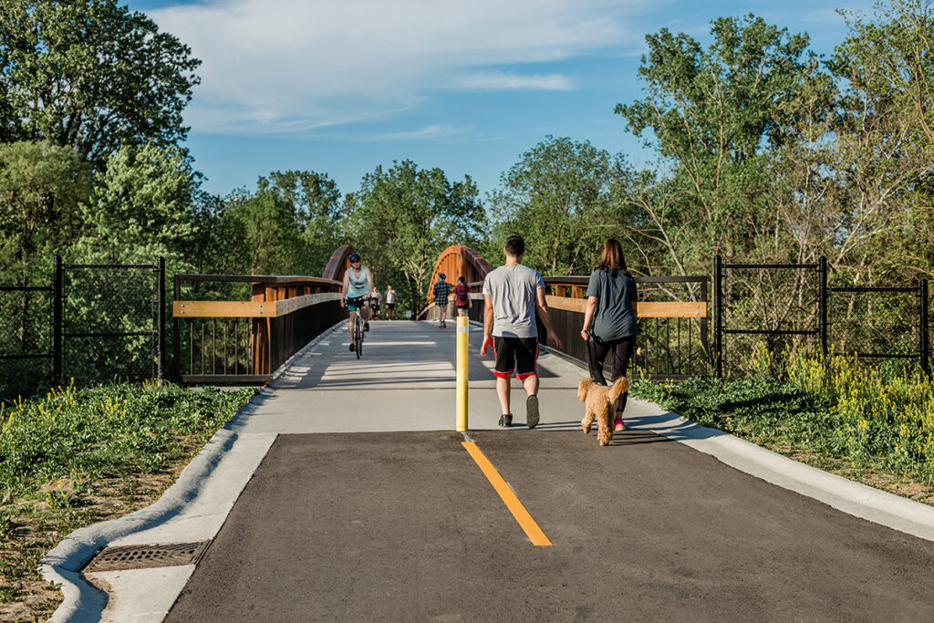People walking and biking on a paved path