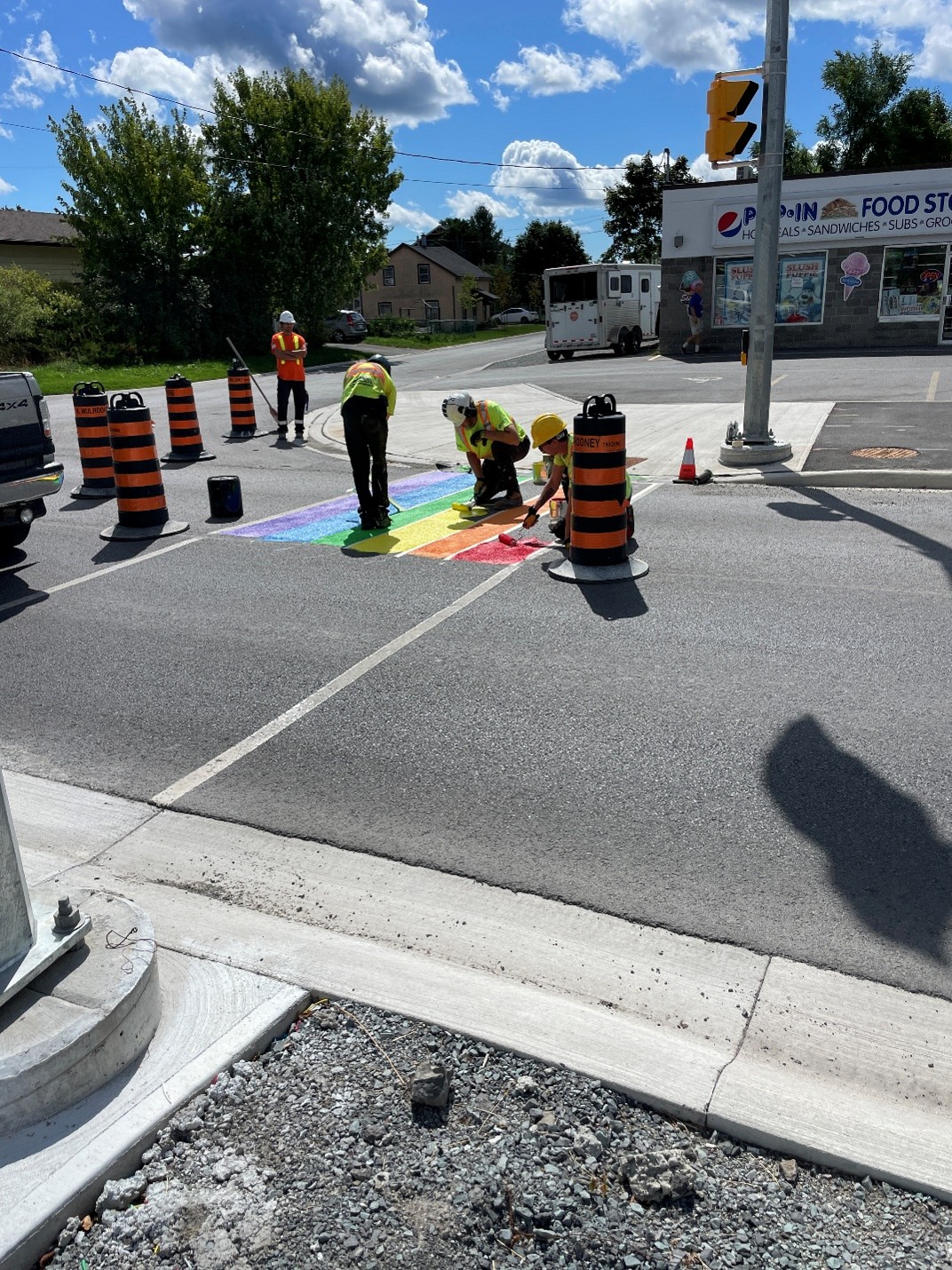 Construction workers painting the crosswalk