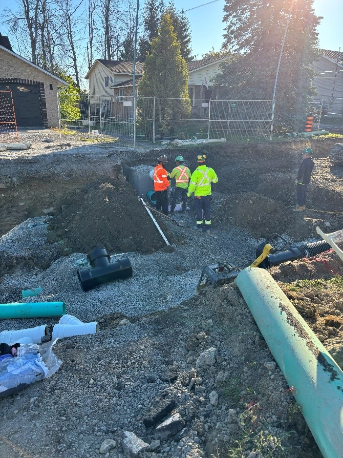 Construction workers working on a pipe
