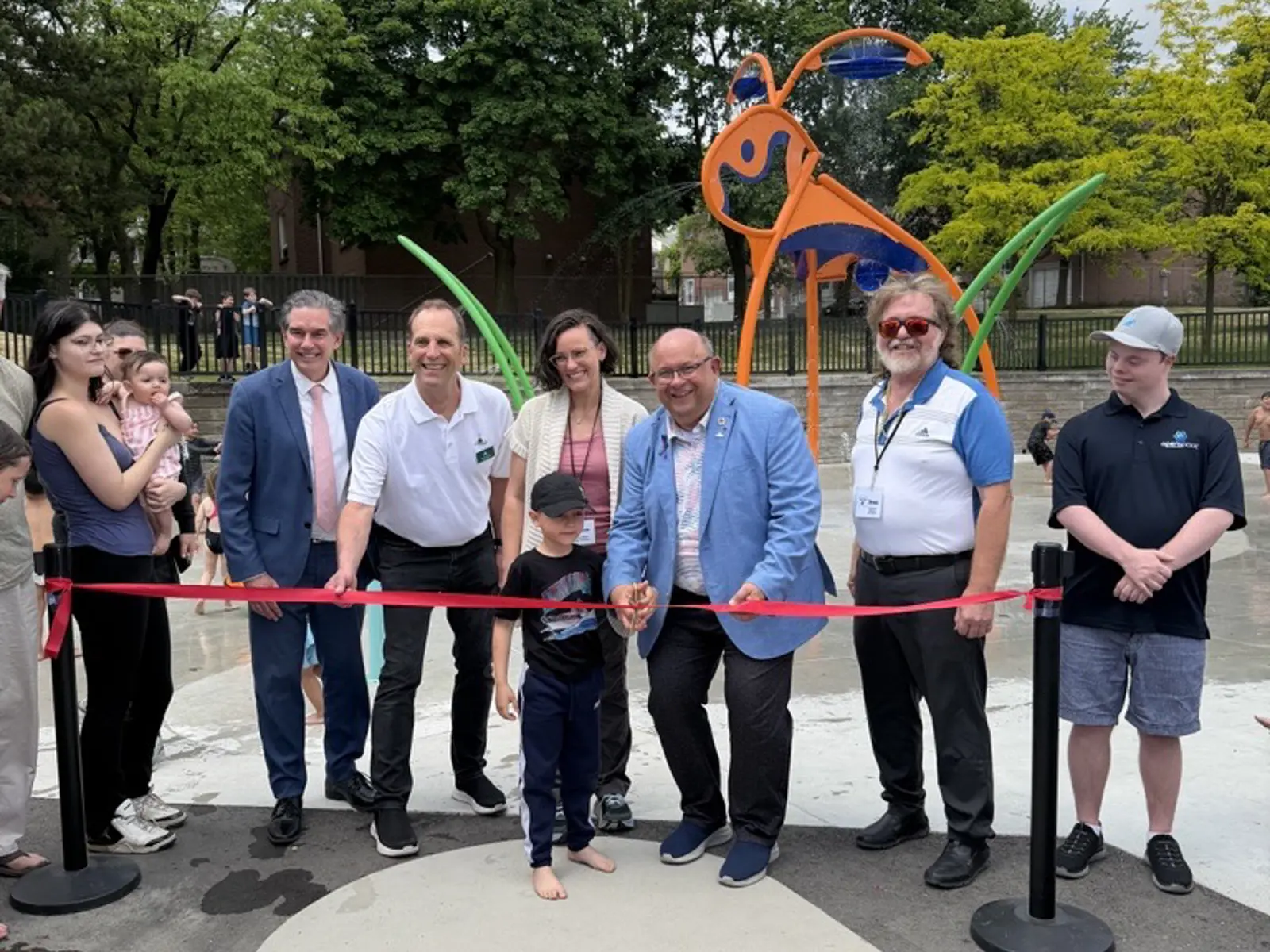 several representatives at a ribbon cutting event for the community centre