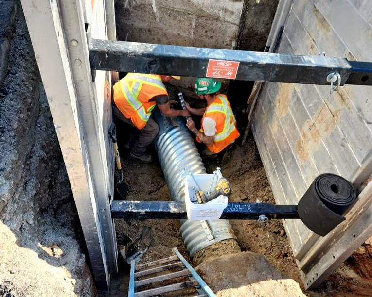 Construction workers fixing a pipe