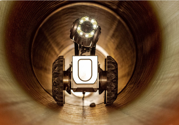 A different camera with bright lights and wheels inside a sewer