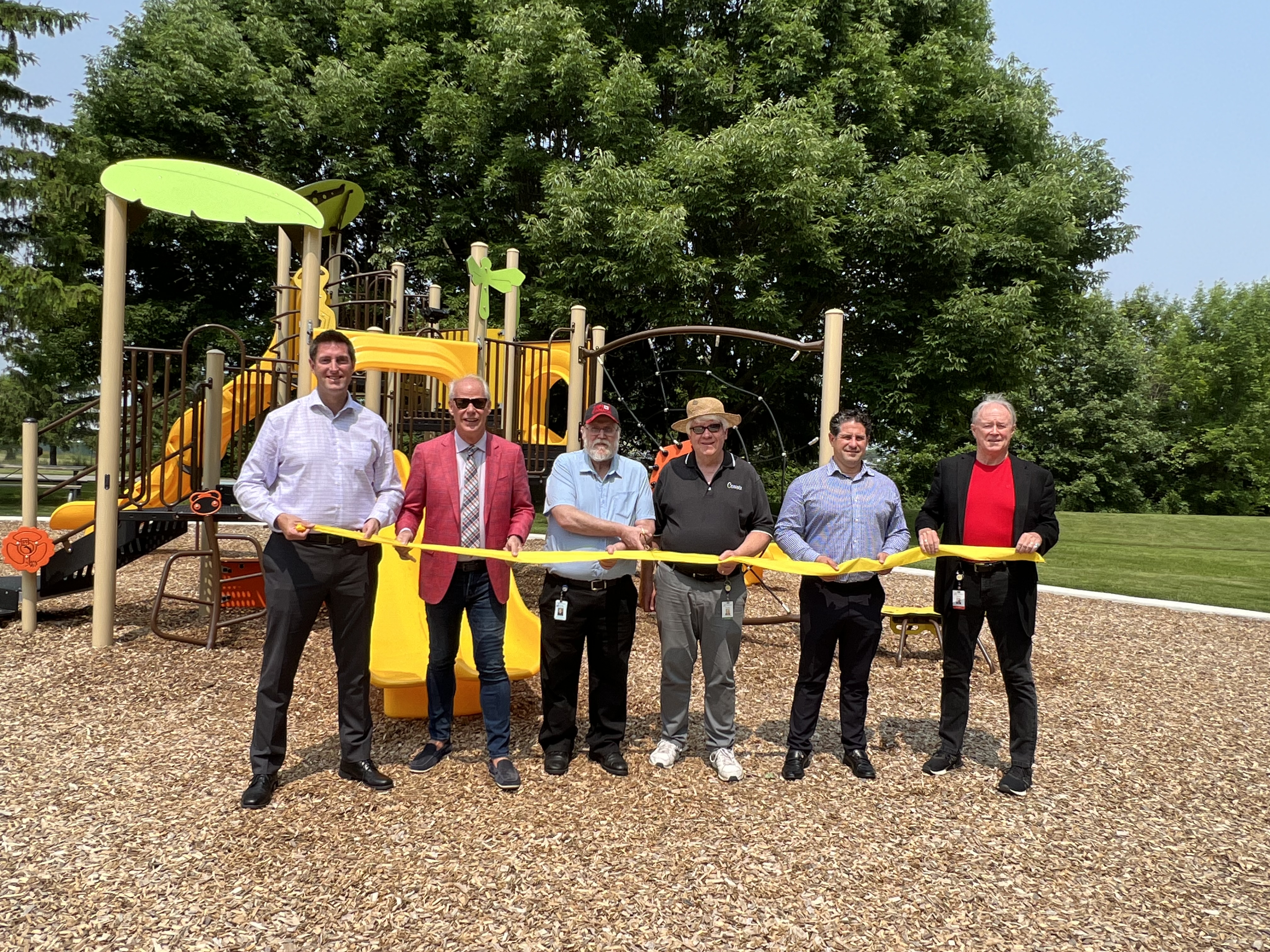 Local delegates gather at a park grand opening in Oshawa. 