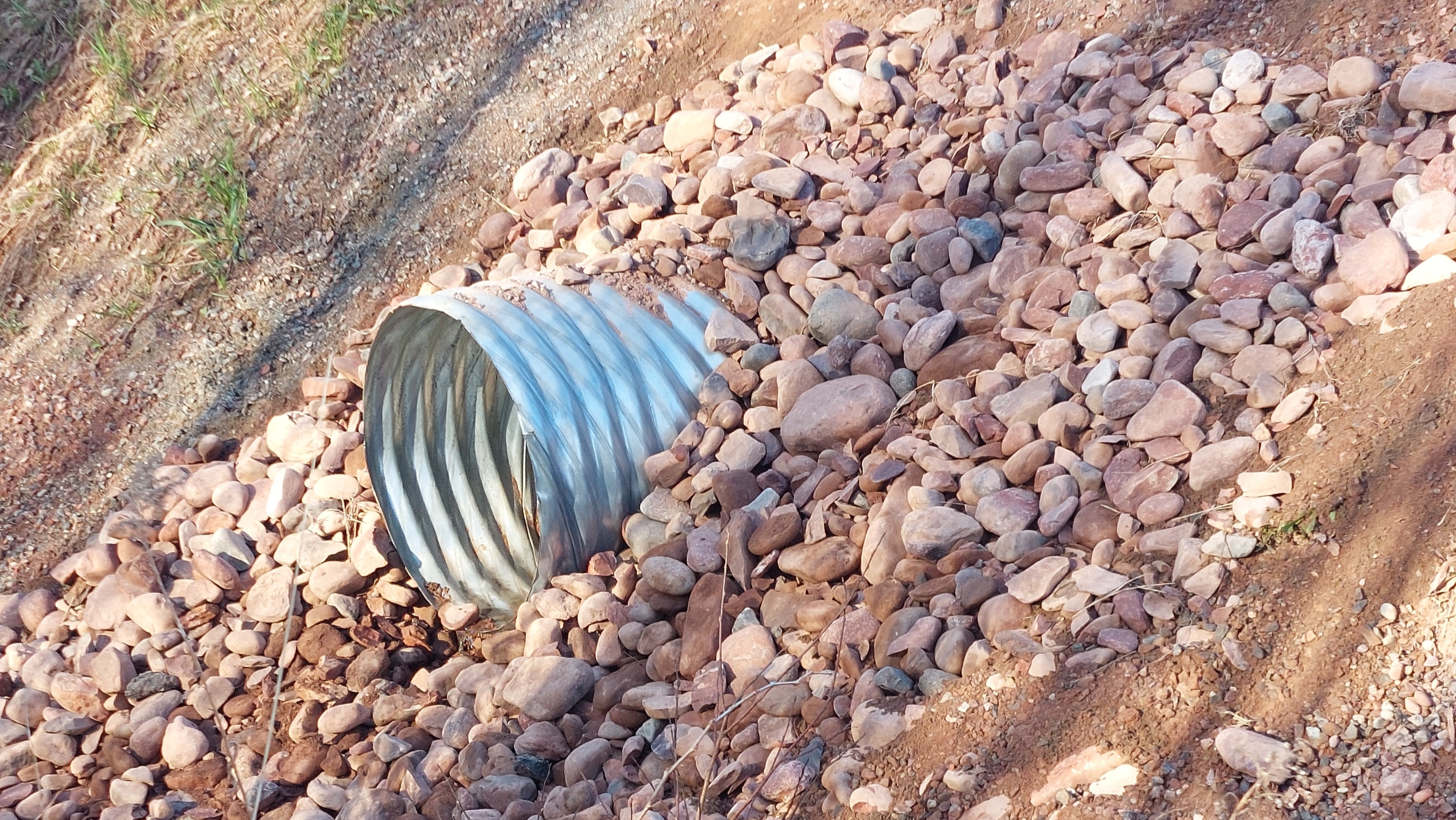 A culvert surrounded by rocks