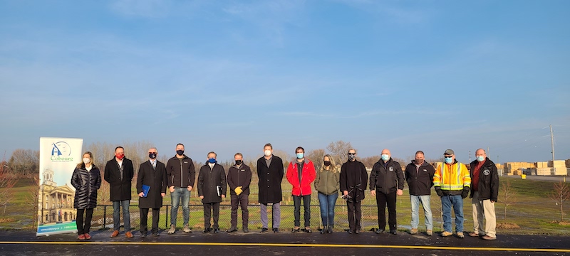 City staff and officials stand at the site of the Midtown Creek Project.