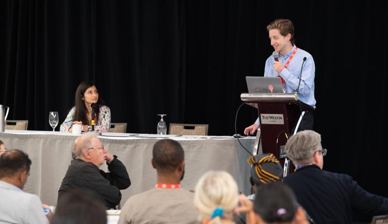 Two presenters on stage in front of an audience