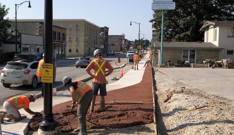 Workers pour coloured concrete as part of the Berford Street reconstruction in downtown Wiarton.