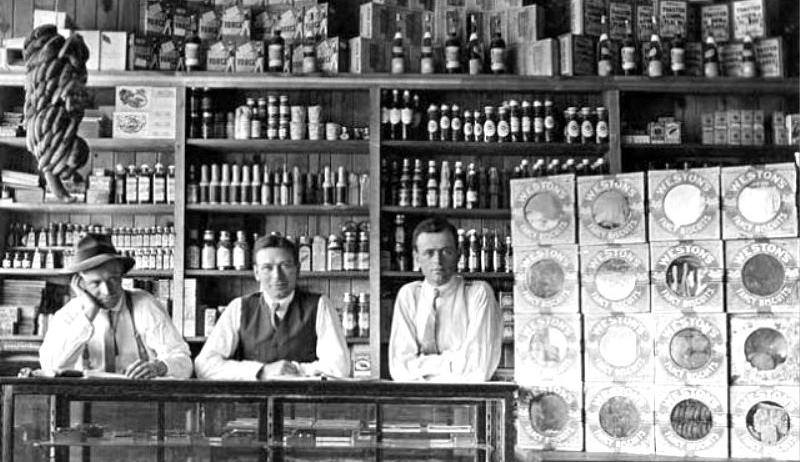 Old photo of men at a store counter