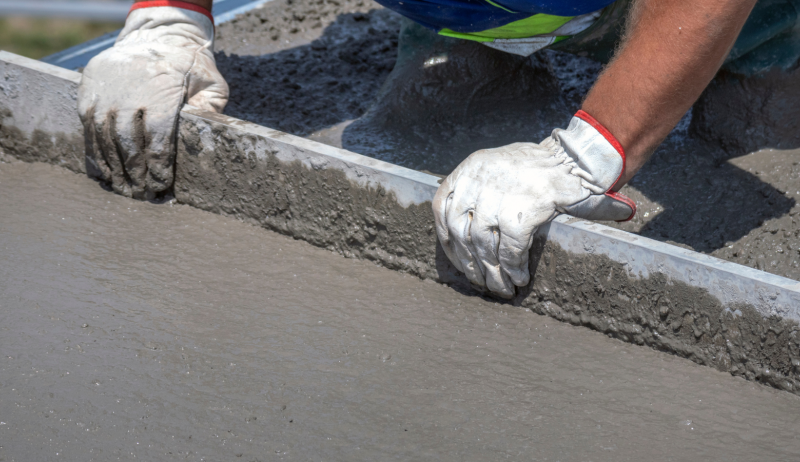 Stock image of a person working with cement.