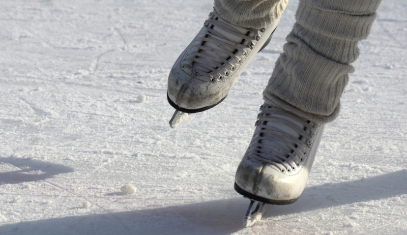 A close-up of a person skating on a public rink. 