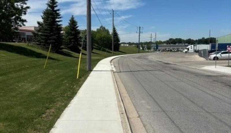 a sidewalk along a curved road