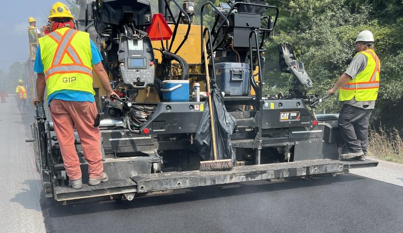 A construction crew paving a road