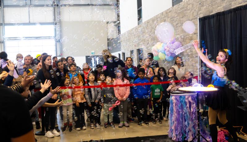 Kids and parents watching a bubble show