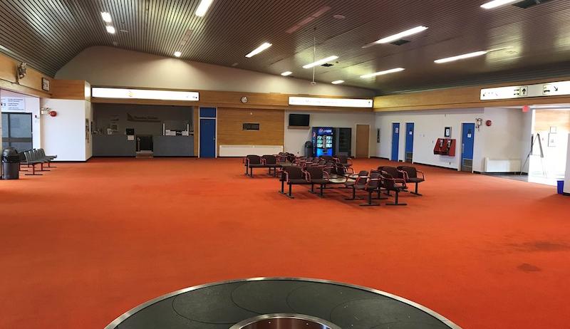 A photo of the Dryden Regional Airport showing the reddish-orange carpet that was in the terminal prior to renovations. 