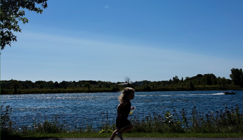 A child running along the waterfront in the City of Cornwall. 