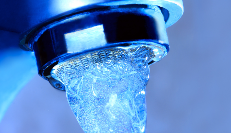 A stock image of water pouring from a tap. 