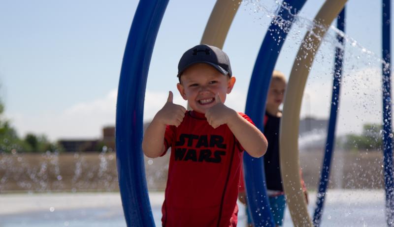 A child gives a thumbs up at the new splash pad in the Municipality of Lakeshore. 