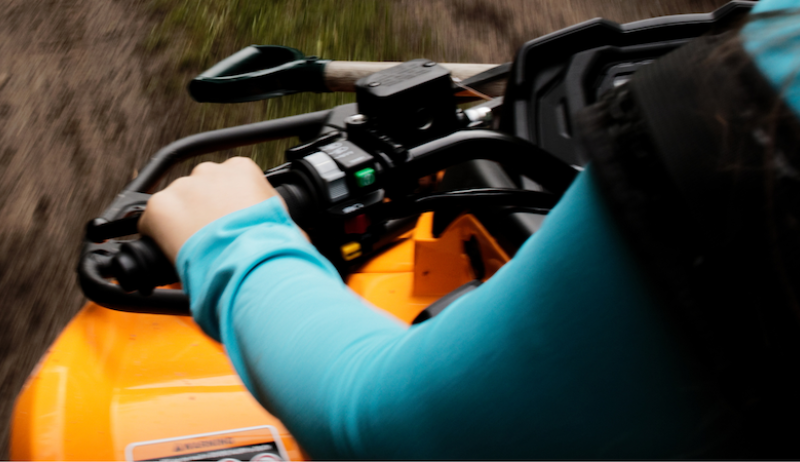 A person driving an ATV. 