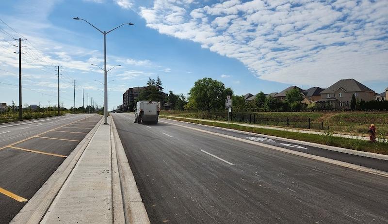 A photo of a vehicle driving on part of the newly widened Sixth Line Road in Oakville. 