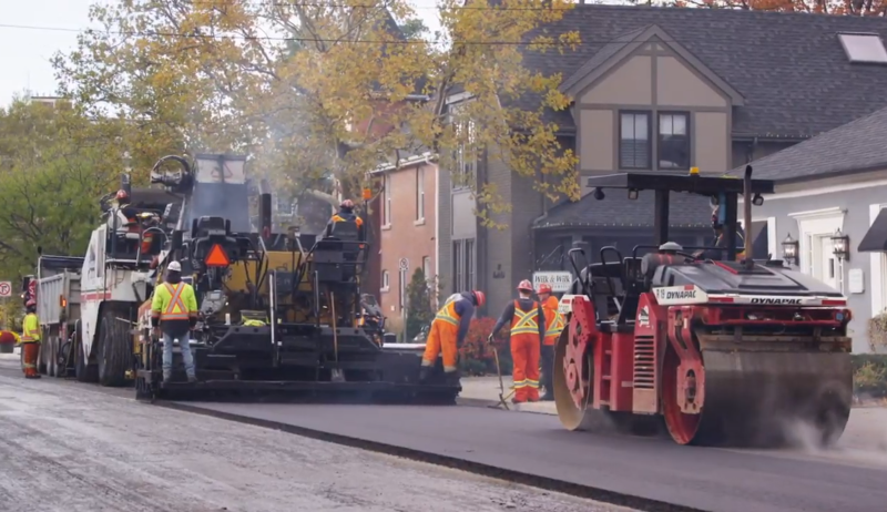 Image of a construction crew resurfacing a road