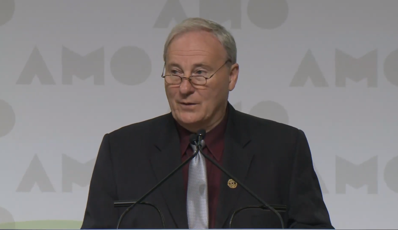 AMO President Jamie McGarvey announces the distribution of an extra $12 million at the 2019 AMO Conference