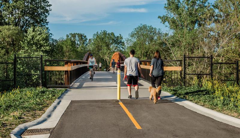 People walking and biking on a paved path