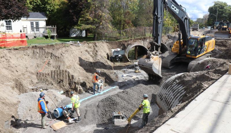 construction workers installing a pipe